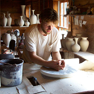 Eck McCanless of Dover Pottery throwing a pot.