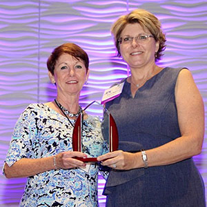 Beverly Stewart (left) receives AENC award.