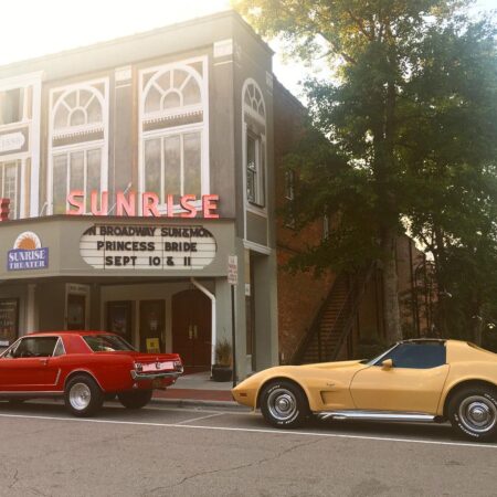 sunrise theater with vintage cars out front